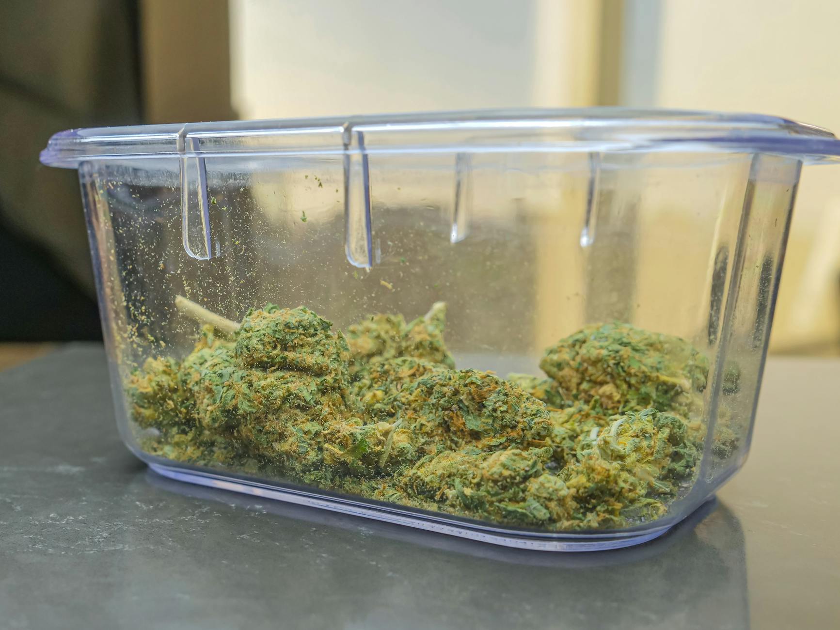 photo of green kush in clear container